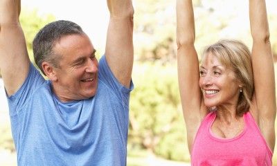 Senior Couple Exercising In Park